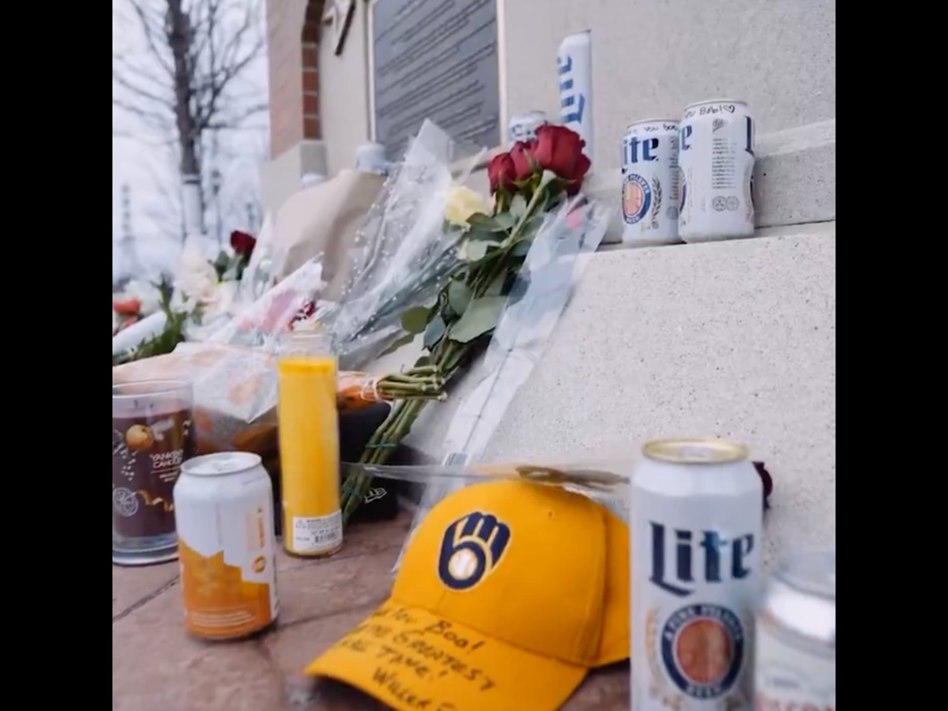 Brewers Fans Have Turned Bob Uecker's Statue Outside The Ballpark Into A Makeshift Memorial, Surrounding It With Flowers And Beer